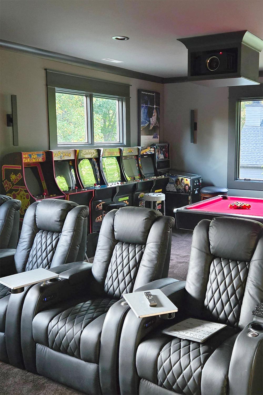 Black diamond-stitched theater seating near arcade games