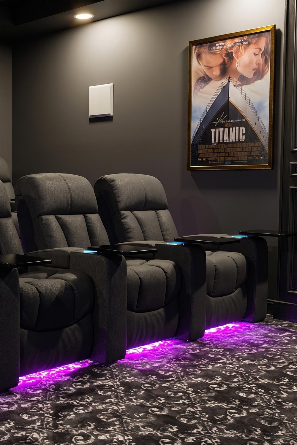 Grey theater recliners with purple under-glow and a movie poster