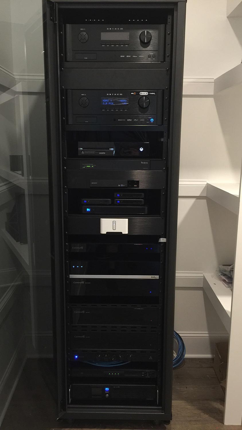 Black server rack filled with audio visual and network equipment