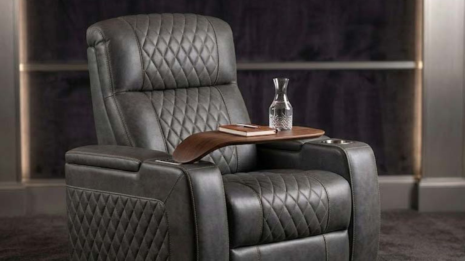 black reclining couches with wooden tray tables