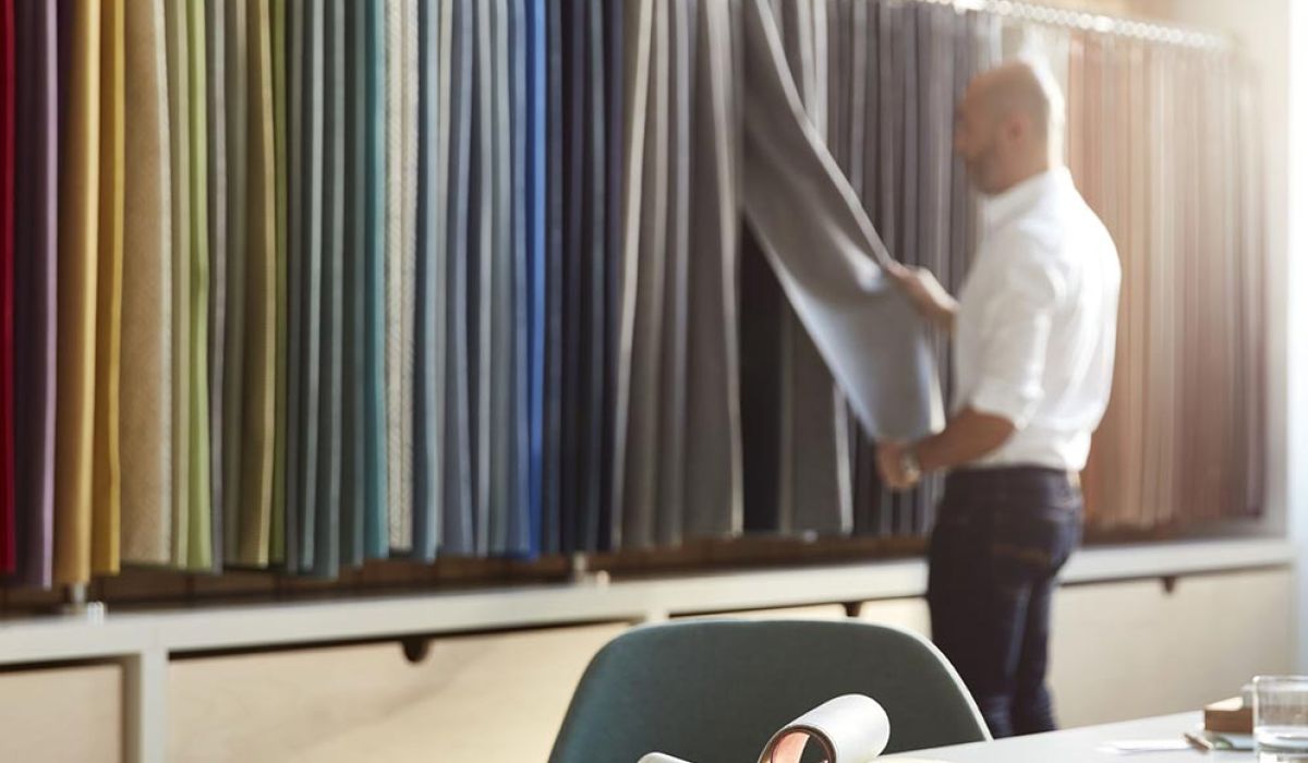 a person selecting fabric swatches at a design center