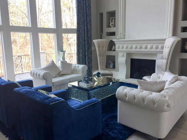 Elegant living room with mirrored table and white sofas