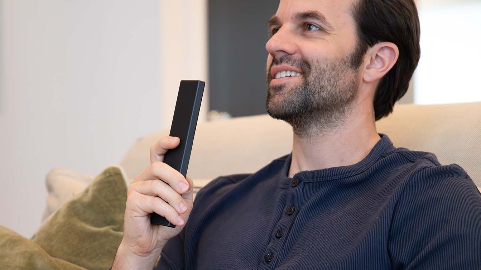 Man holding a Control4 Remote