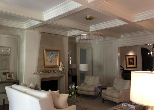 Bright living room with white sofas and a stone fireplace