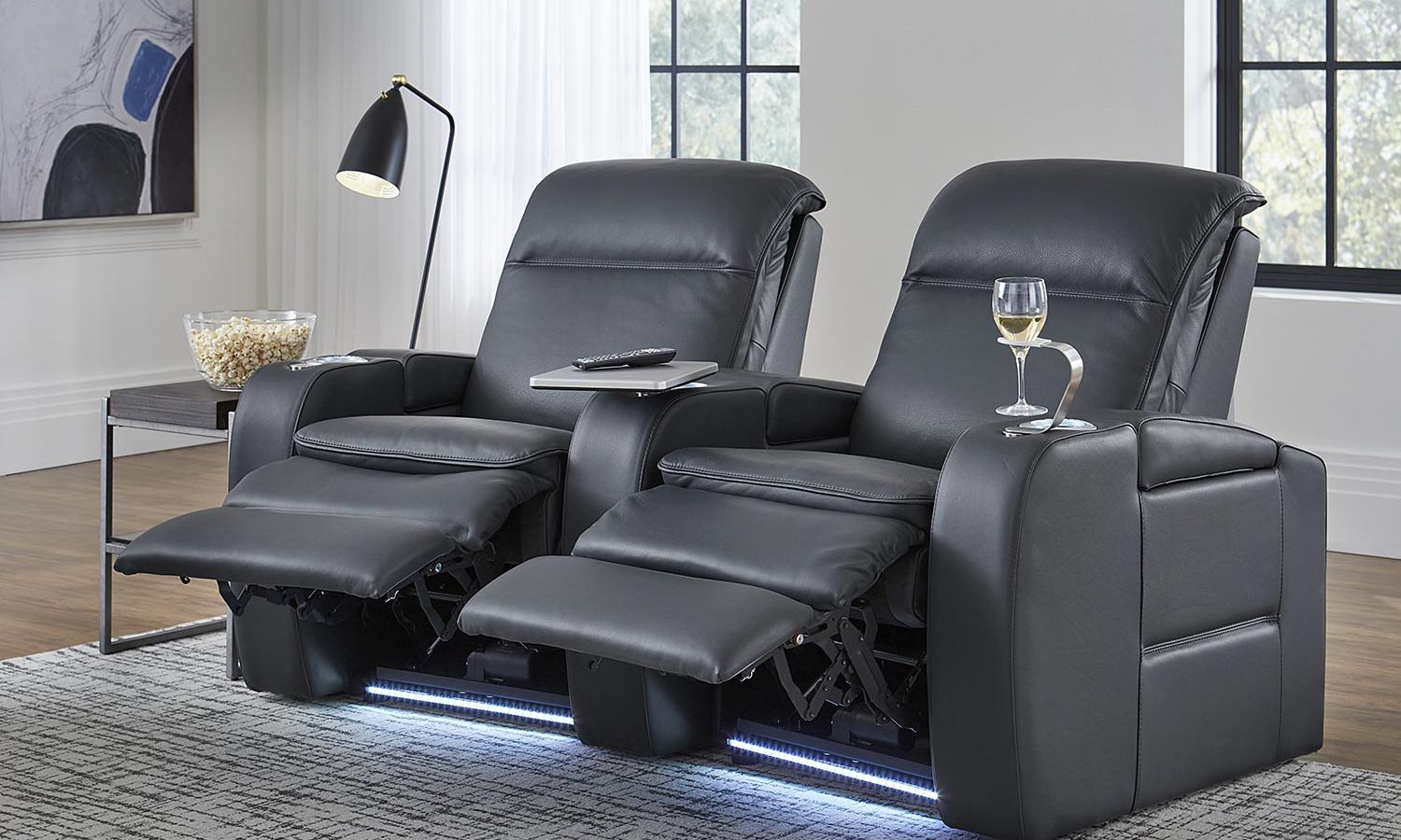 two reclined leather theater seats in a bright room