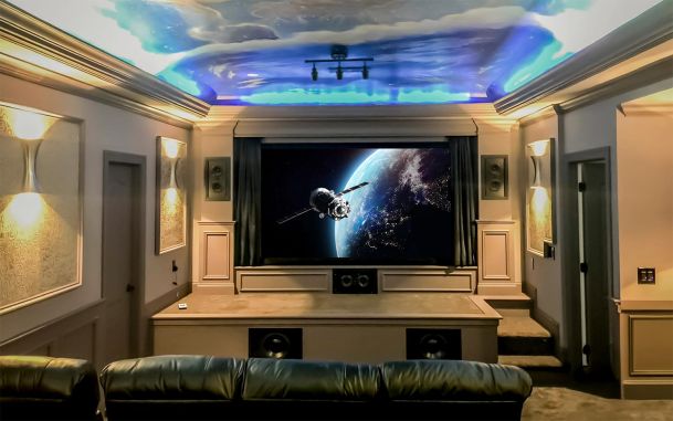 Home theater with leather seats a large screen and painted sky ceiling