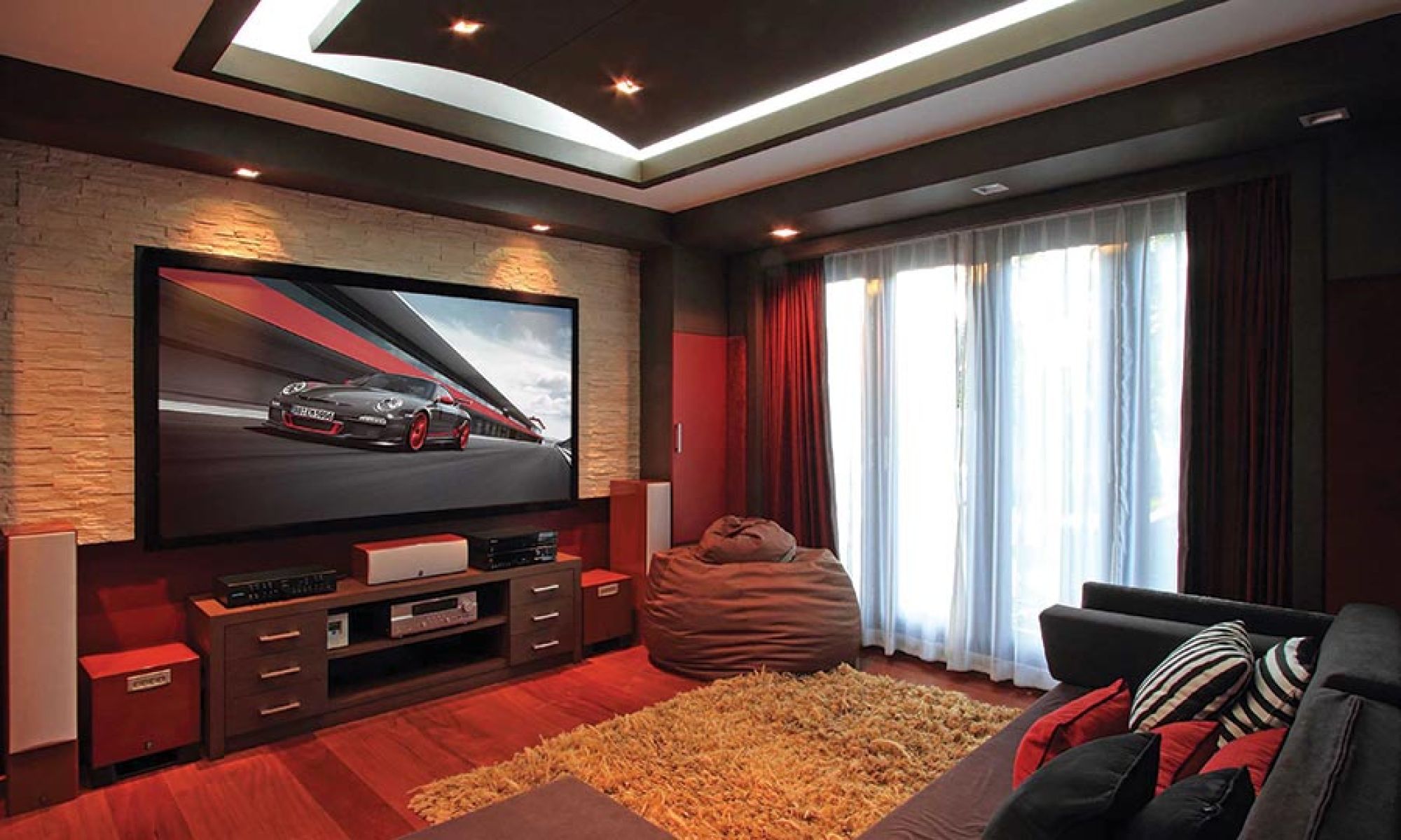 Large projection screen in a home theater room with red accents