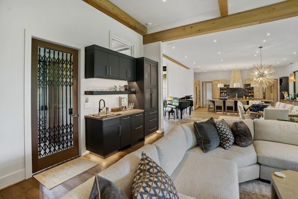 Living space featuring a dark wet bar and under-cabinet lighting