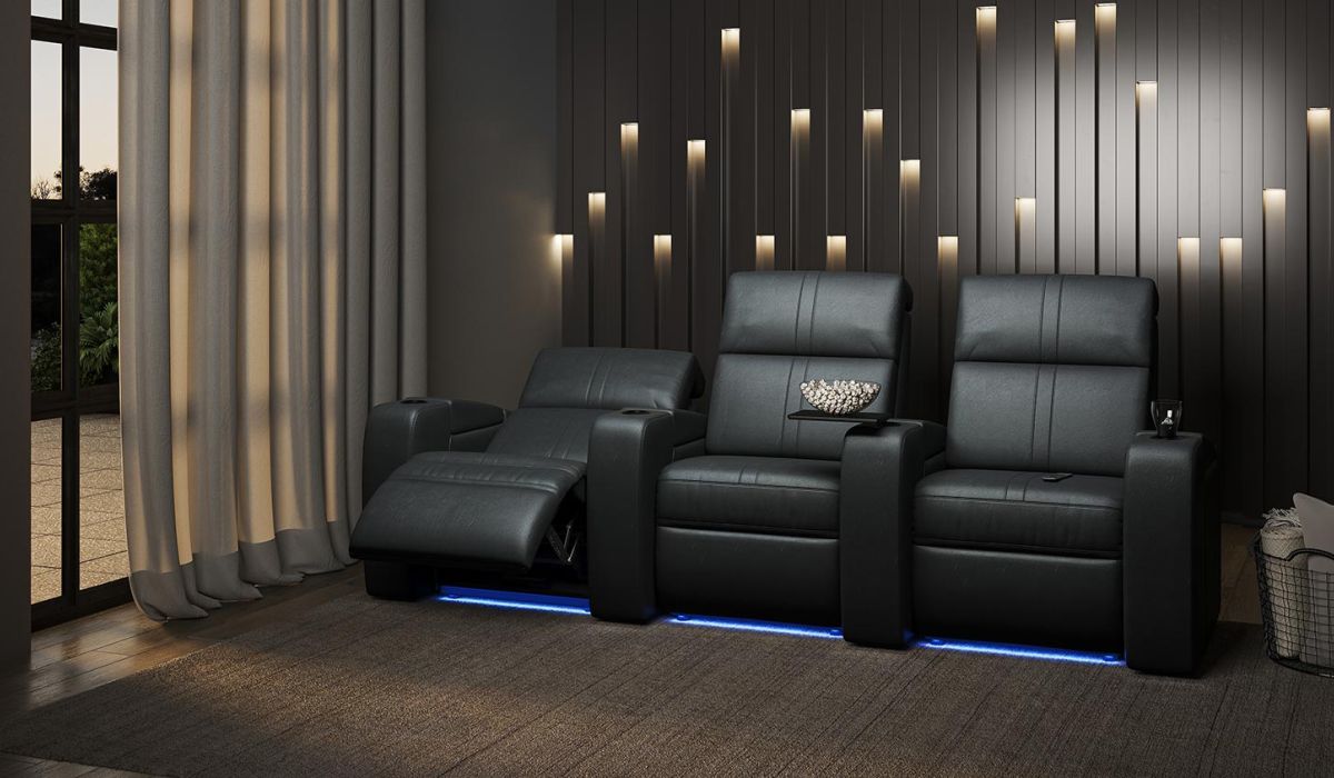 three brown leather theater seats near a wood burning fireplace