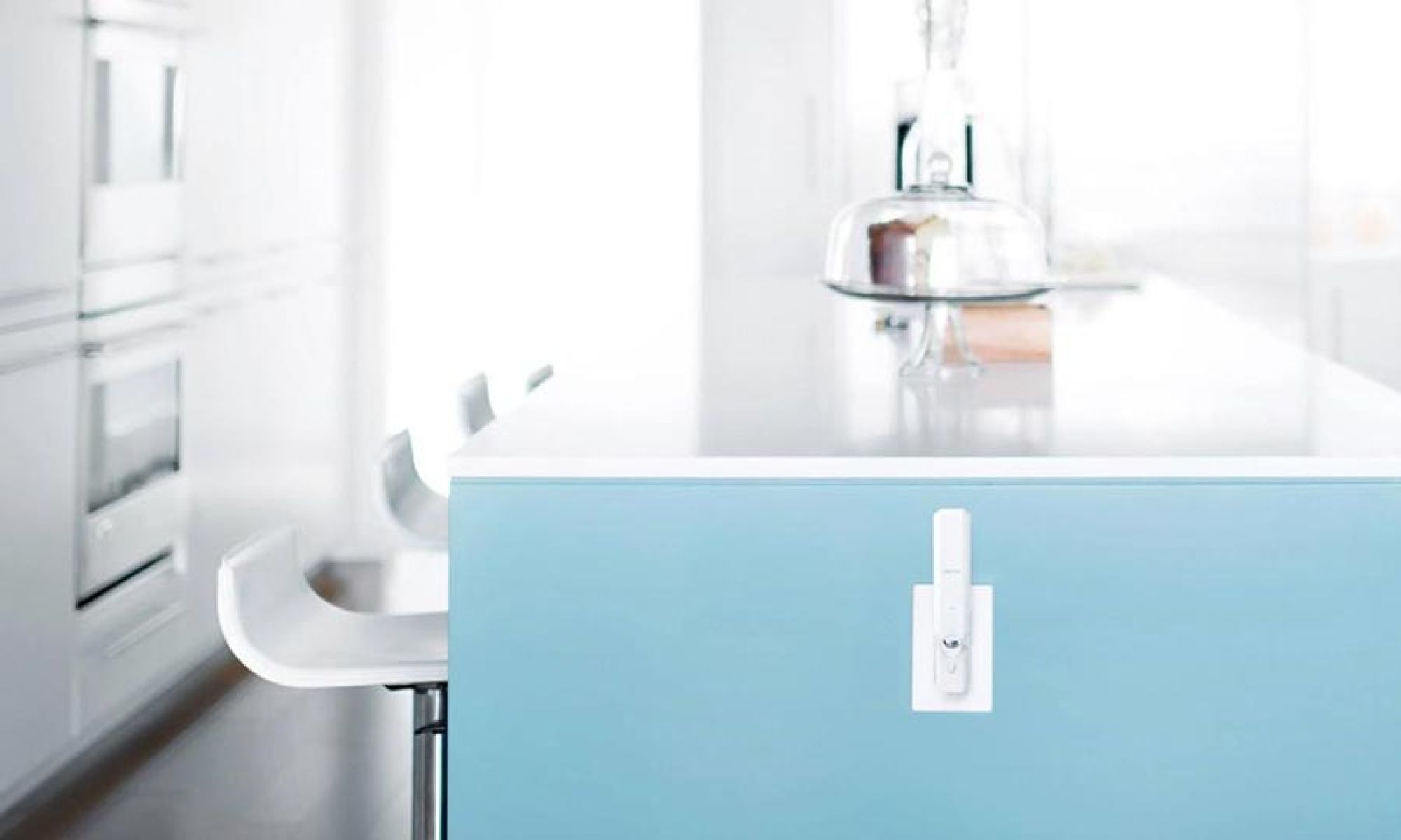 Small white network device plugged into a blue kitchen island