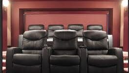 Home theater with black reclining chairs.